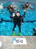 DSC02263 Just entered water. Giving an OK sign to my instructor. The darn mask keeps fogging all the time, despite the anti-fog sea drops. Once in the water, the temperature inside my wetsuits drops a little bit. It still seems like finding yourself in an oven.