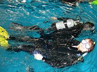 DSC02275 Trying the same rescue swim as before. This time, I am the distressed diver, and Roberto is the rescuer. Notice that I unzipped my wetsuit as much as I could, on a (vain) hope that water would cool me down a little bit.